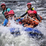 friends having fun during white water rafting malaysia