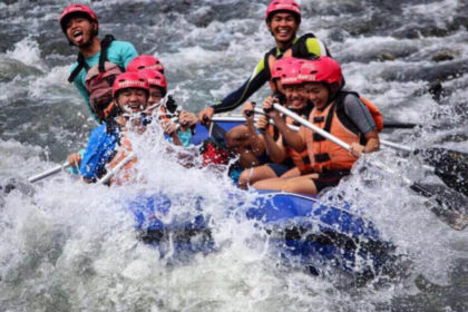 friends having fun during white water rafting malaysia