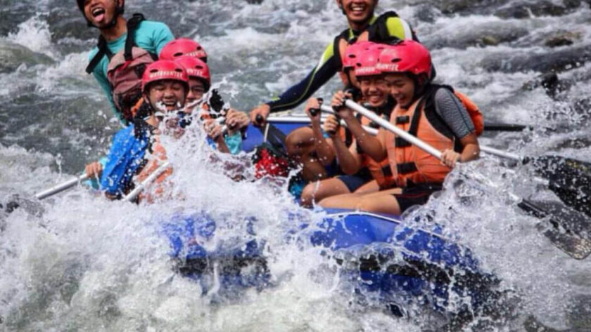 friends having fun during white water rafting malaysia
