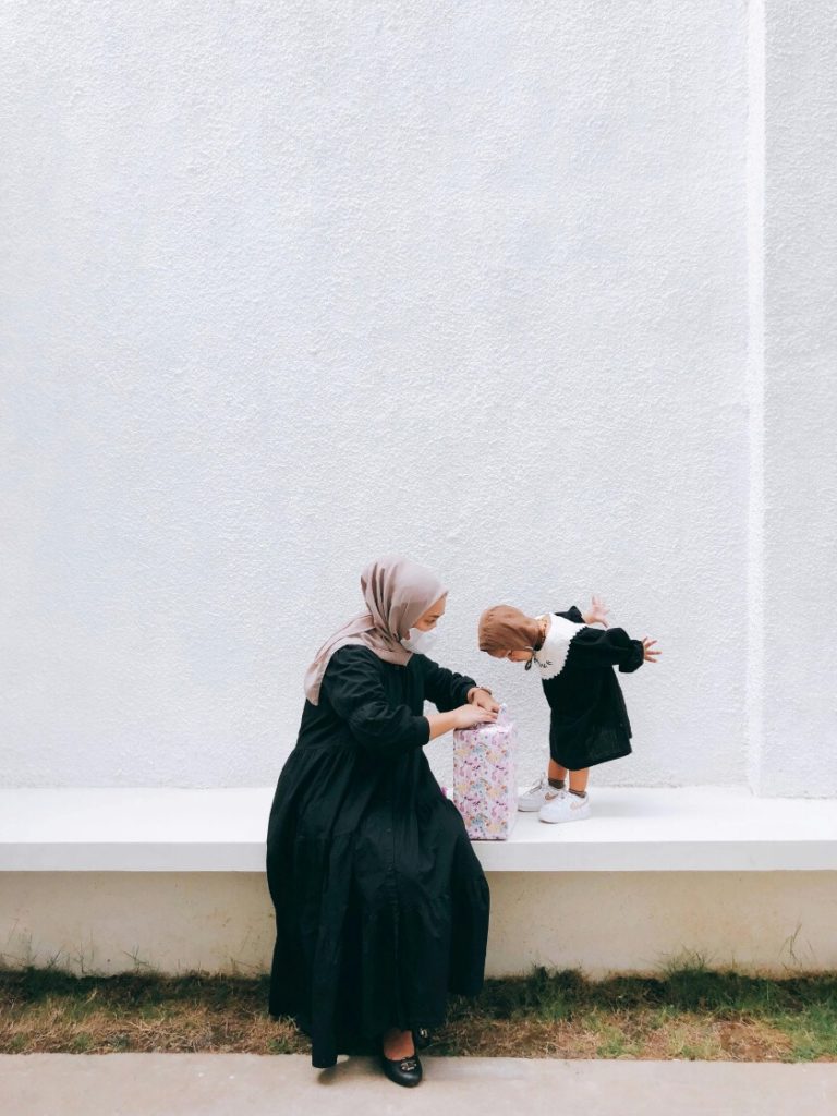 little girl excited as mother opens mother's day present